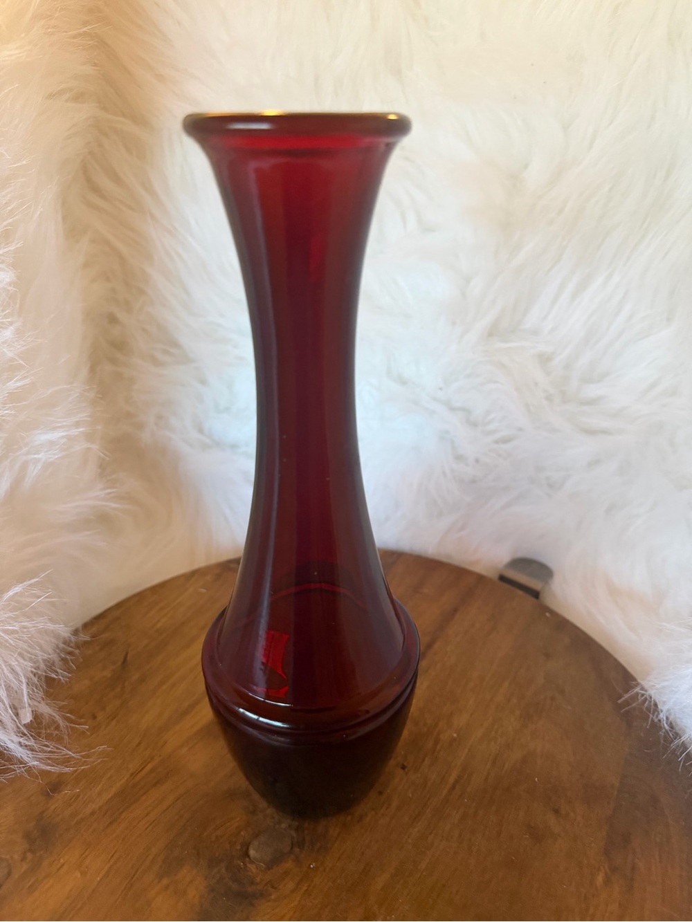 A vintage ruby red art glass bud vase with vertical ribbing.